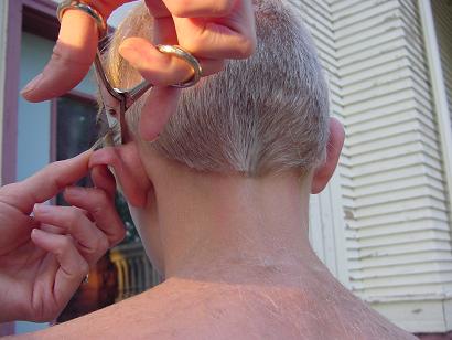 cutting a boy's hair with scissors